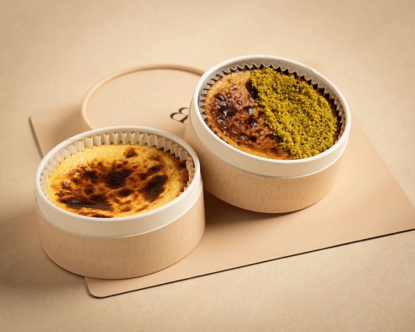 BasK Pair Nº 1 — two small Basque cheesecakes, Lady Madrid CC and Pistachio Royale CC, elegant dessert pairing from Dubai, by Bask Cheesecake boutique.