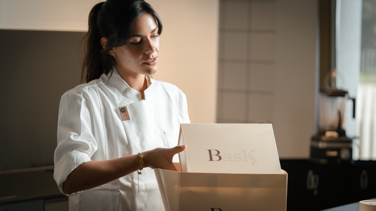 Head chef of Bask Cheesecake boutique packaging cheesecake premium boxes with BasK brand logo.
