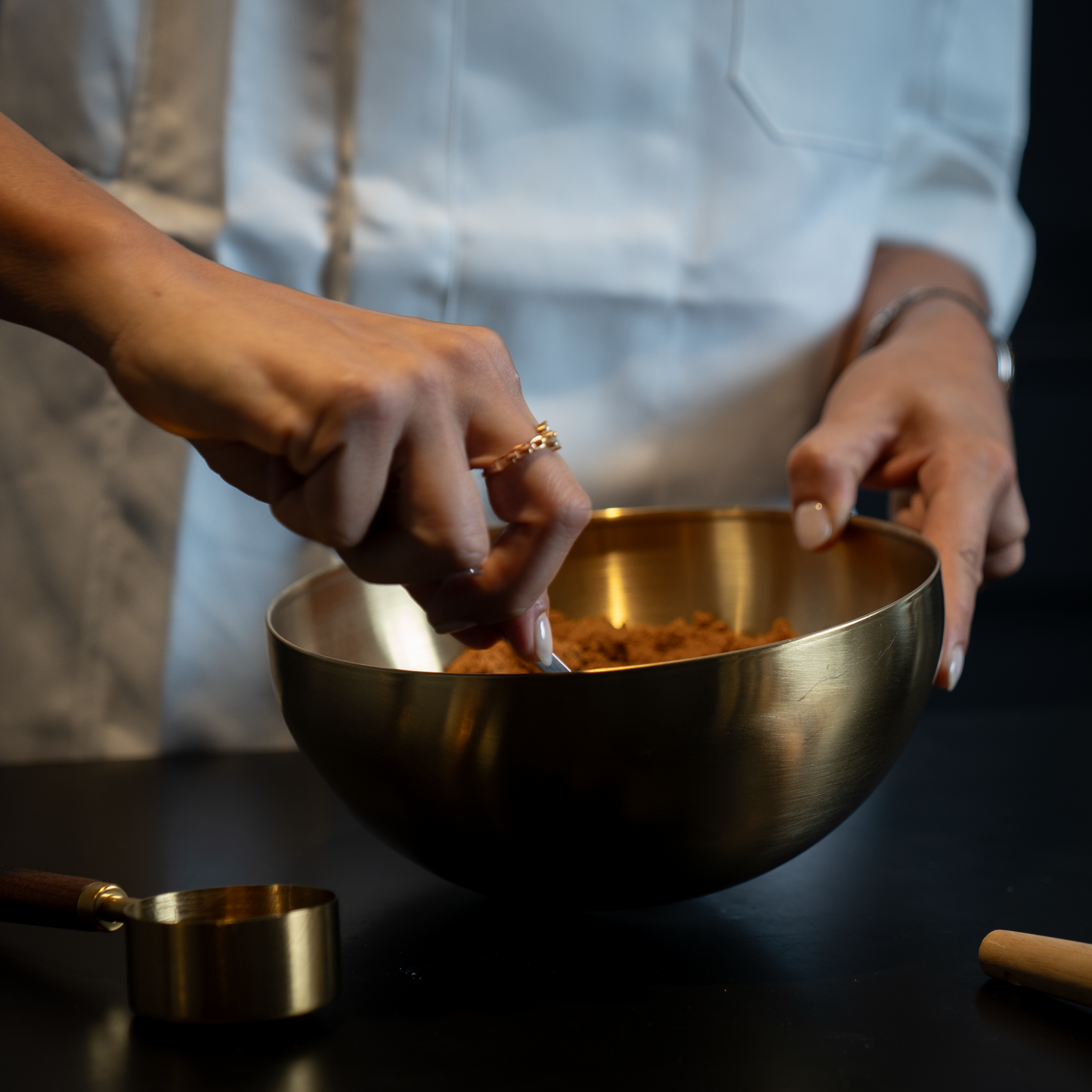 Pastry chef preparing the cheesecake biscuit base